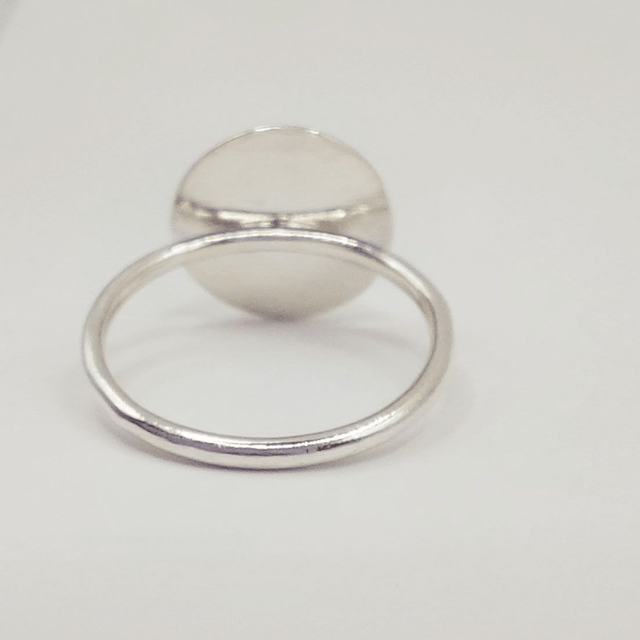 Sterling silver disc ring with green amber gemstone
